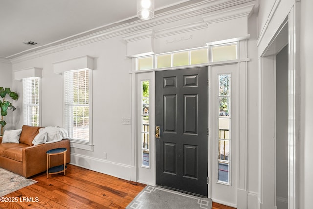 2211 Wilson Dr, Beaufort, SC 29902 - foyer entrance featuring wood finished floors, ornamental molding, and plenty of natural light