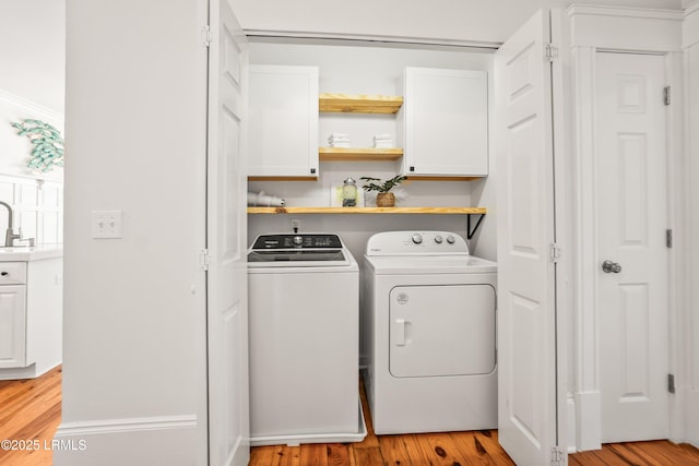 2211 Wilson Dr, Beaufort, SC 29902 - laundry room with cabinet space, washing machine and dryer, and light wood-style flooring