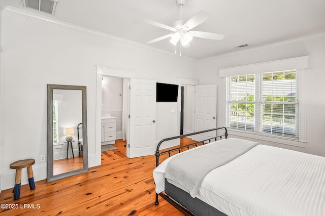 2211 Wilson Dr, Beaufort, SC 29902 - bedroom featuring ornamental molding, light wood-style flooring, connected bathroom, and a ceiling fan