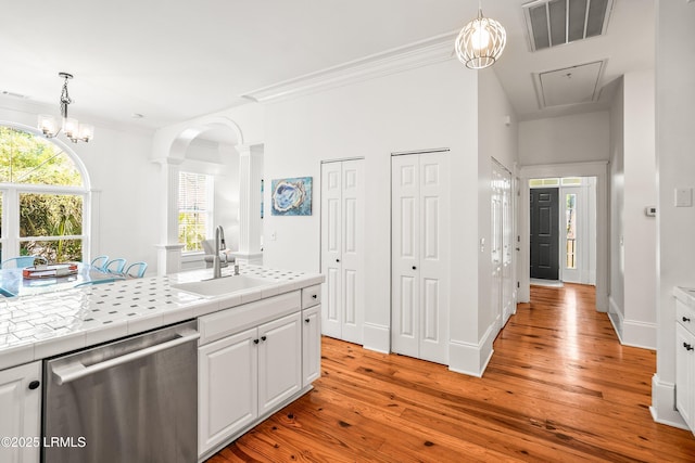 2211 Wilson Dr, Beaufort, SC 29902 - kitchen featuring dishwasher, tile countertops, ornate columns, arched walkways, and light wood-type flooring