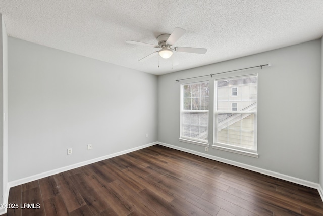 unfurnished room featuring a textured ceiling, a ceiling fan, baseboards, and dark wood-style flooring