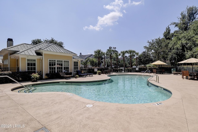 pool with a patio and fence