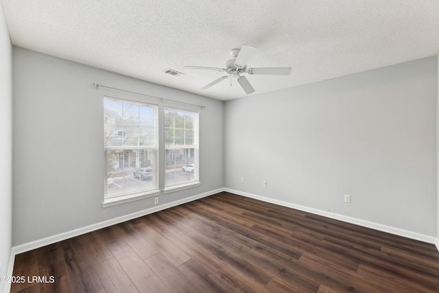 unfurnished room with visible vents, baseboards, a textured ceiling, a ceiling fan, and dark wood-style flooring