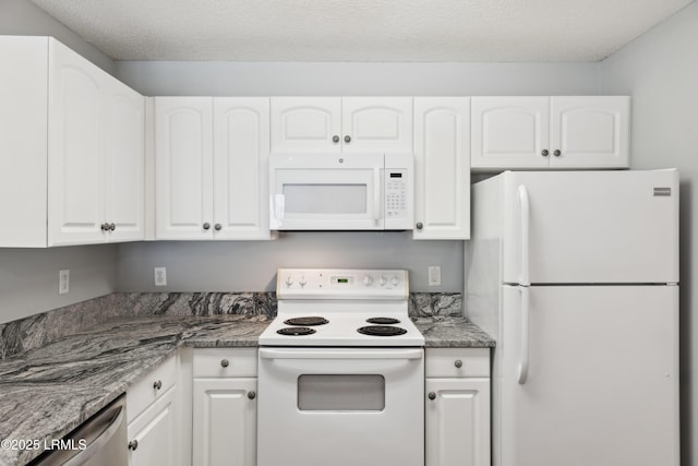 kitchen featuring white cabinets, white appliances, and a textured ceiling