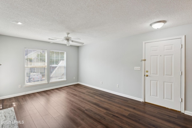 interior space with visible vents, a textured ceiling, baseboards, ceiling fan, and dark wood-style flooring