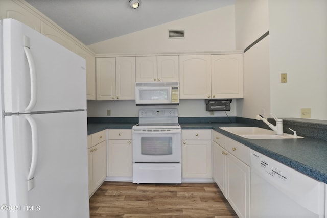 5 Gumtree Rd Unit I-32, Hilton Head Island, SC 29926 - kitchen with white appliances, lofted ceiling, wood finished floors, dark countertops, and white cabinets