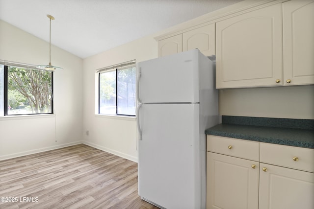 5 Gumtree Rd Unit I-32, Hilton Head Island, SC 29926 - kitchen with freestanding refrigerator, dark countertops, light wood finished floors, vaulted ceiling, and hanging light fixtures