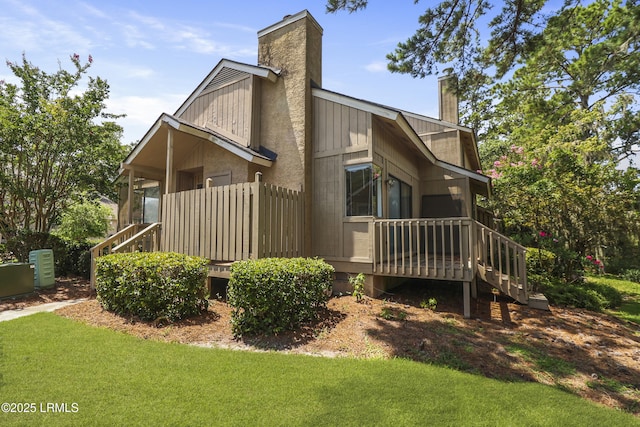 5 Gumtree Rd Unit I-32, Hilton Head Island, SC 29926 - view of home's exterior with a chimney, a yard, and stairway