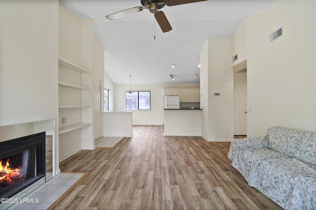 5 Gumtree Rd Unit I-32, Hilton Head Island, SC 29926 - unfurnished living room with a ceiling fan, a fireplace with flush hearth, light wood finished floors, built in features, and high vaulted ceiling