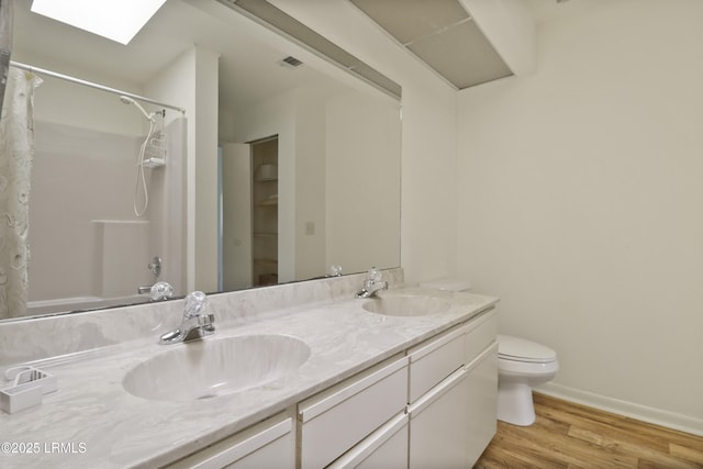 5 Gumtree Rd Unit I-32, Hilton Head Island, SC 29926 - full bathroom featuring double vanity, wood finished floors, and a skylight