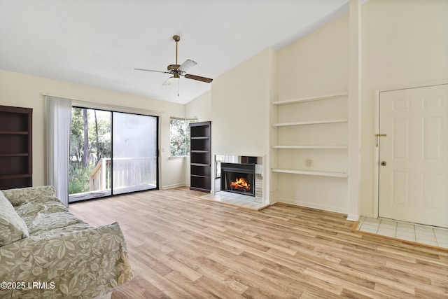 5 Gumtree Rd Unit I-32, Hilton Head Island, SC 29926 - unfurnished living room with wood finished floors, ceiling fan, a fireplace with flush hearth, and high vaulted ceiling