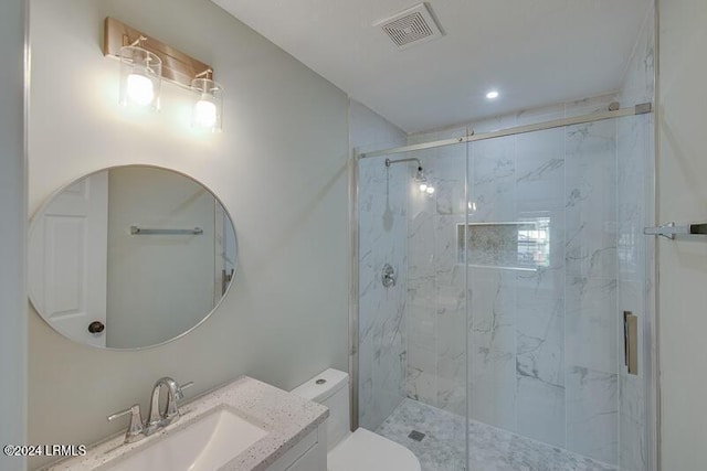 bathroom featuring an enclosed shower, vanity, and toilet