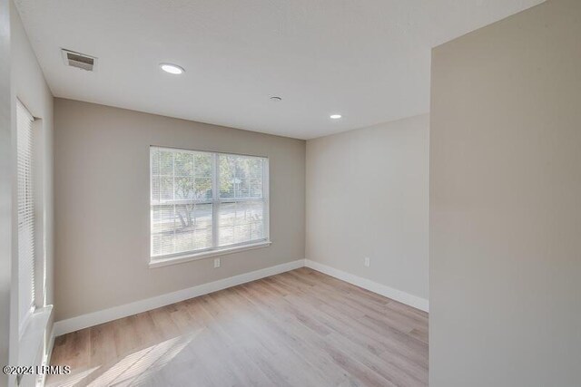 spare room featuring light wood-type flooring