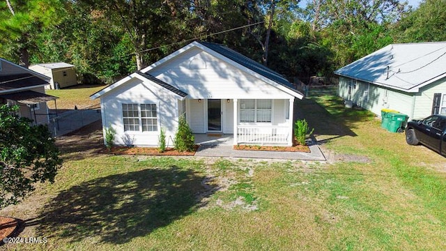 bungalow-style house with a front yard and covered porch