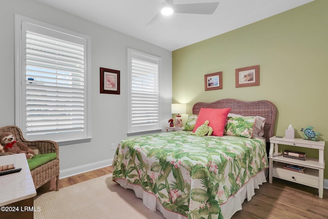 bedroom with hardwood / wood-style floors and ceiling fan