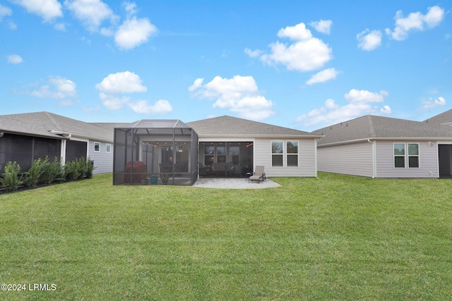 back of house featuring glass enclosure and a lawn