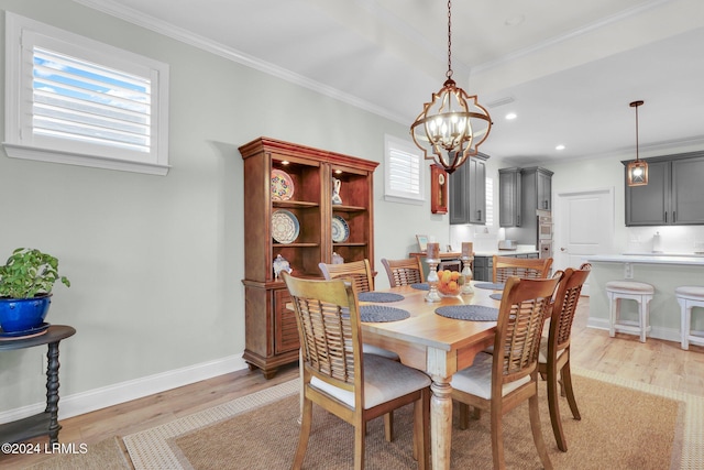 dining space featuring a notable chandelier, crown molding, and light wood-type flooring