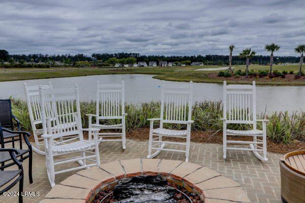 view of patio featuring a water view and an outdoor fire pit