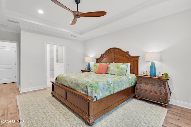 bedroom featuring connected bathroom, crown molding, light hardwood / wood-style floors, and ceiling fan