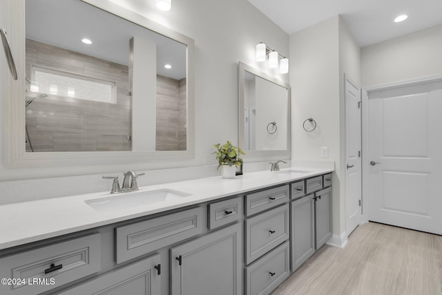 bathroom featuring vanity and tiled shower