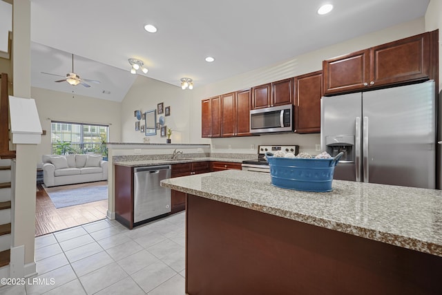 151 Bella Way, Beaufort, SC 29906 - kitchen with stainless steel appliances, a peninsula, light tile patterned floors, a ceiling fan, and lofted ceiling