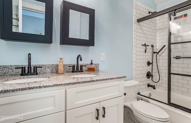 full bathroom with vanity, toilet, and combined bath / shower with glass door