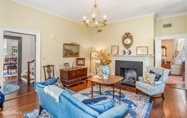 living room with ornamental molding, a notable chandelier, and dark hardwood / wood-style flooring