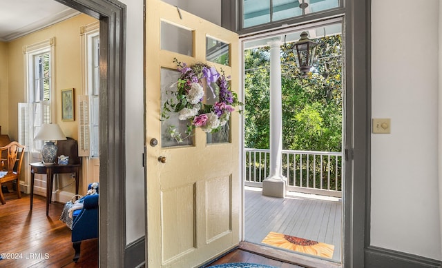 doorway to outside featuring hardwood / wood-style floors and ornamental molding