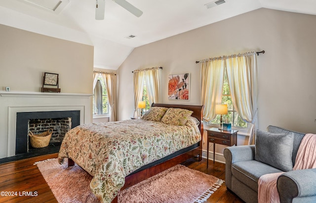 bedroom with multiple windows, vaulted ceiling, dark wood-type flooring, and ceiling fan