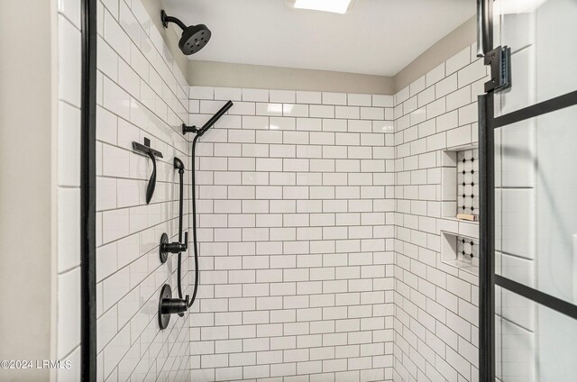 bathroom with a tile shower