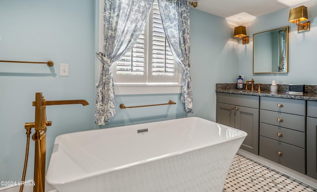 bathroom with vanity and a tub