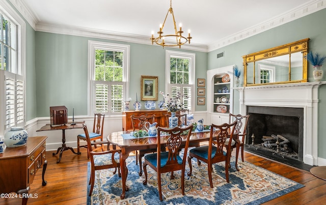 dining space featuring an inviting chandelier, a healthy amount of sunlight, wood-type flooring, and crown molding