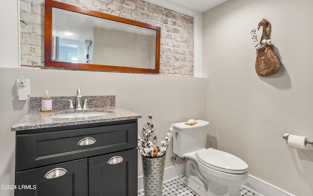 bathroom featuring tile patterned flooring, vanity, and toilet