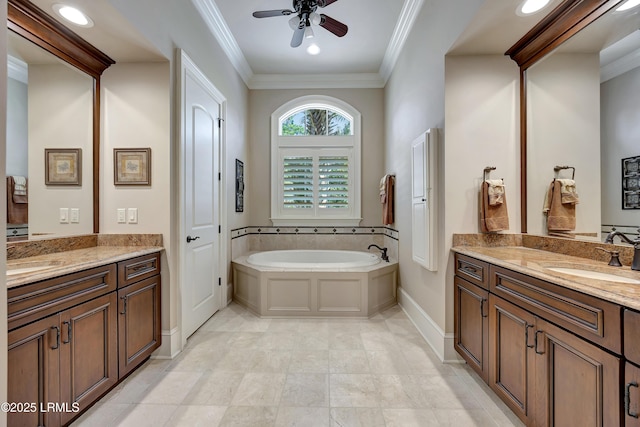 bathroom with ceiling fan, ornamental molding, vanity, and a tub