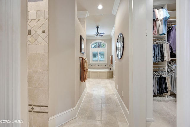 hall featuring light tile patterned floors and crown molding