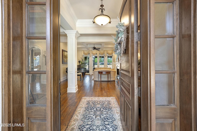 hallway with decorative columns, beamed ceiling, coffered ceiling, crown molding, and dark wood-type flooring