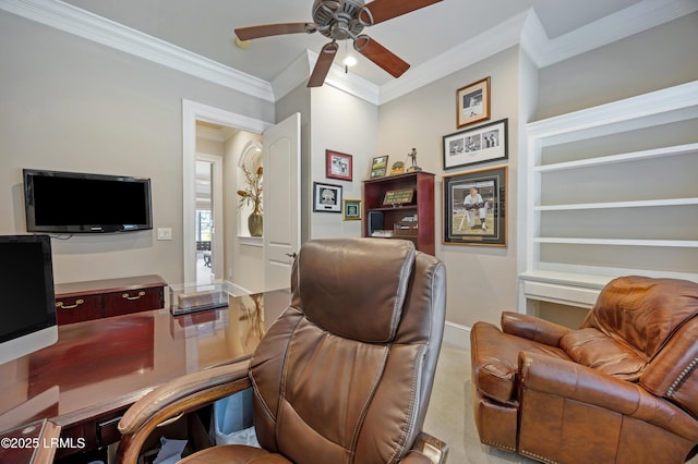 home office with crown molding, ceiling fan, and carpet