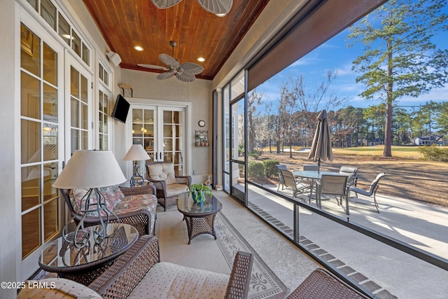 sunroom with wooden ceiling, french doors, and ceiling fan