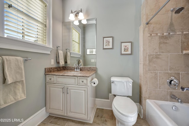 full bathroom featuring tiled shower / bath combo, vanity, tile patterned floors, and toilet