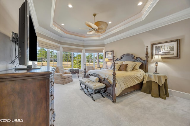 bedroom with a raised ceiling, crown molding, carpet, and ceiling fan