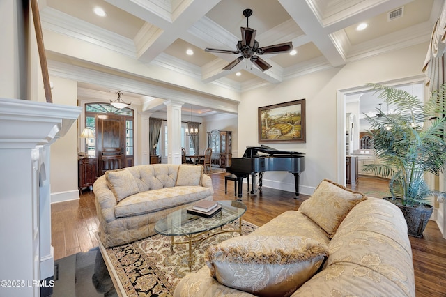 living room with dark hardwood / wood-style floors, beamed ceiling, and ornate columns