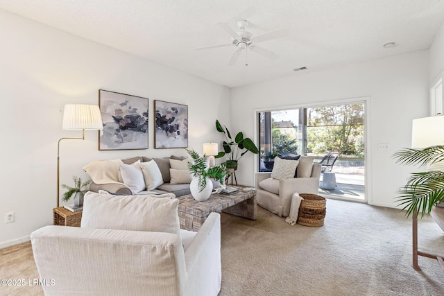 living room featuring light carpet and ceiling fan