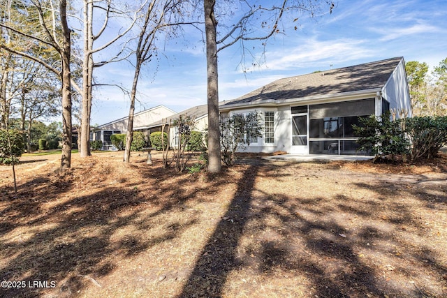 back of property featuring a sunroom