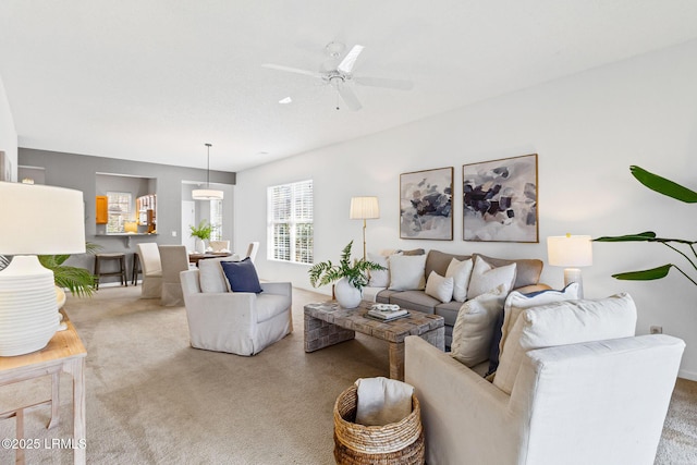 living room with ceiling fan and carpet