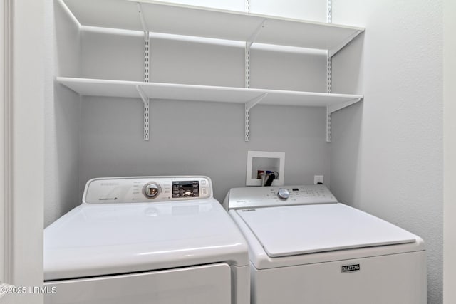 clothes washing area with washer and dryer