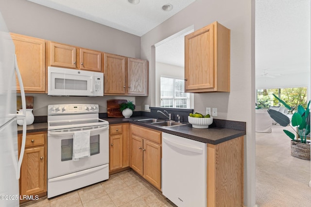 kitchen featuring white appliances, sink, and a textured ceiling