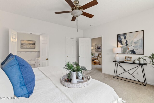 carpeted bedroom featuring connected bathroom and ceiling fan