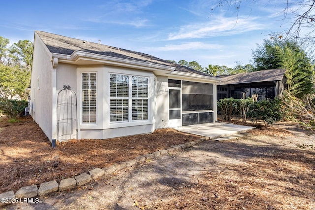 back of property featuring a patio area and a sunroom