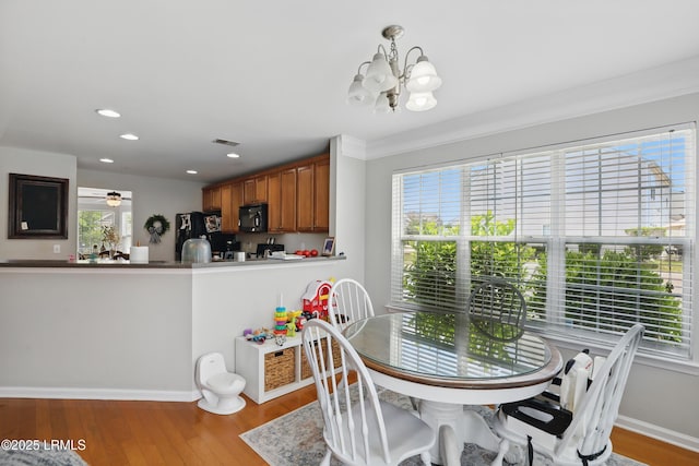 2239 Blakers Blvd, Bluffton, SC 29909 - dining room with a chandelier, healthy amount of natural light, wood finished floors, baseboards, and recessed lighting