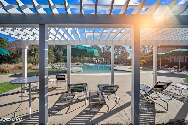 view of patio featuring a community pool and a pergola